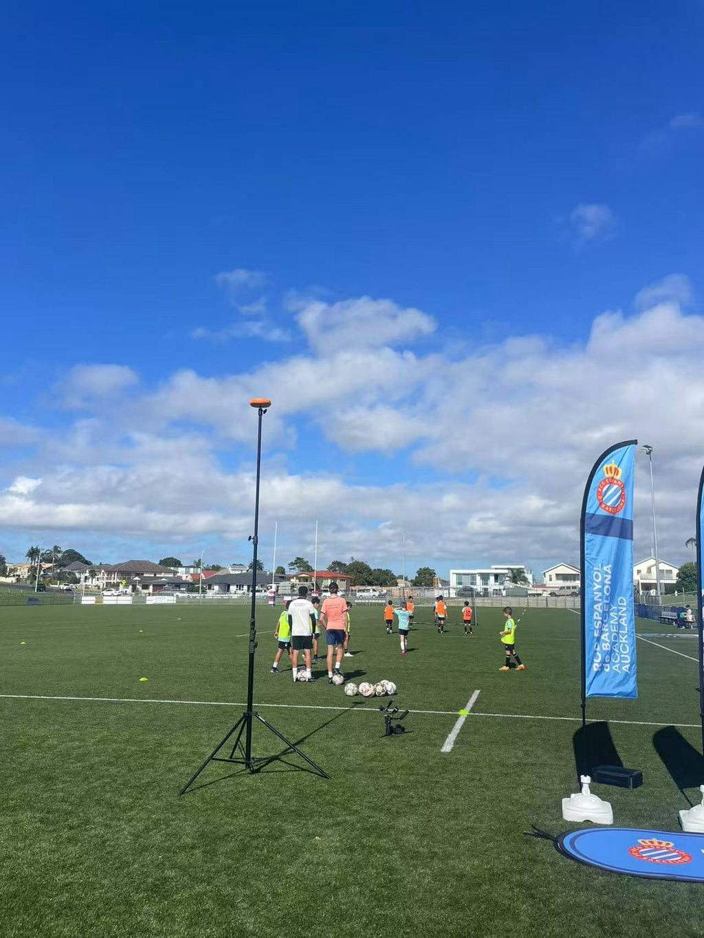 Ballr AI Sports Camera on a tripod recording a youth football academy training session