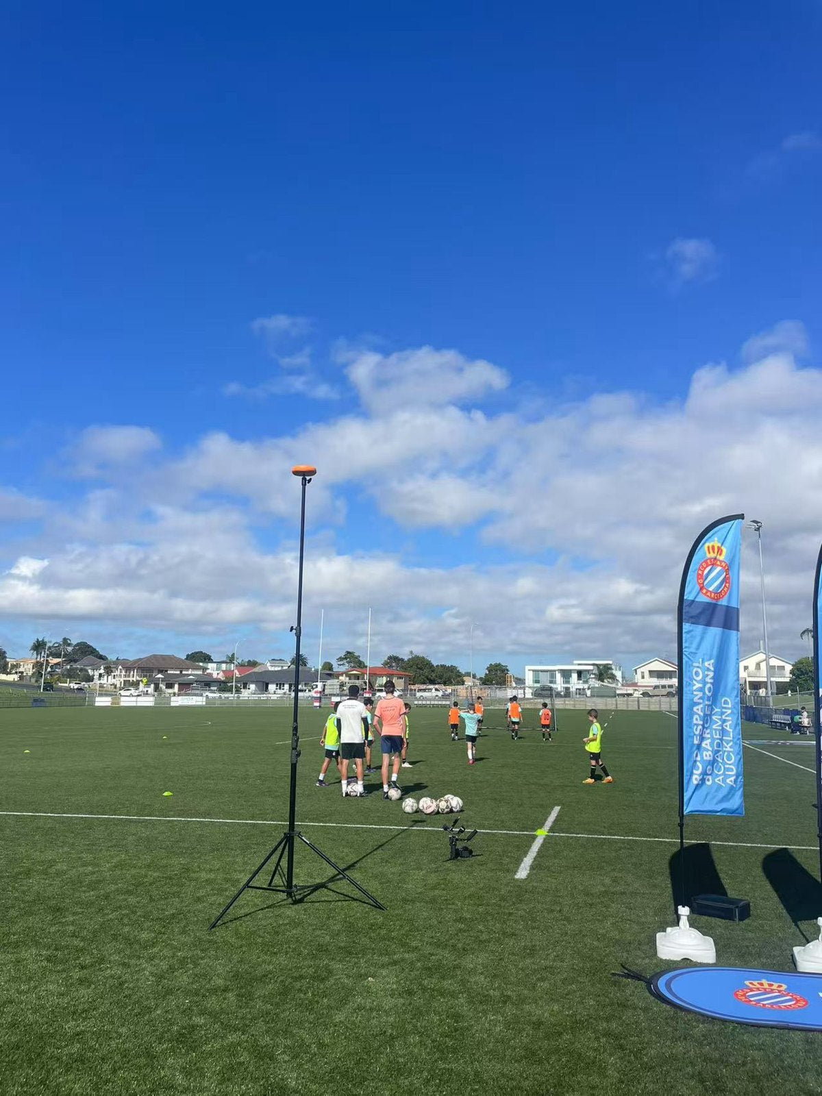 Ballr AI Sports Camera on a tripod recording a youth football academy training session