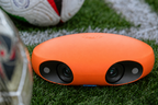 Ballr AI Sports Camera close-up on the grass beside the pitch