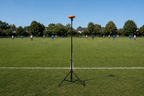 Ballr AI Sports Camera behind the touchline, aligned with midfield; tripod not included