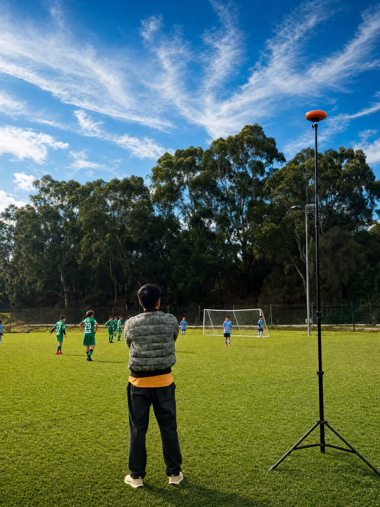 Parents watch the game on the sidelines, and the Ballr camera automatically records it
